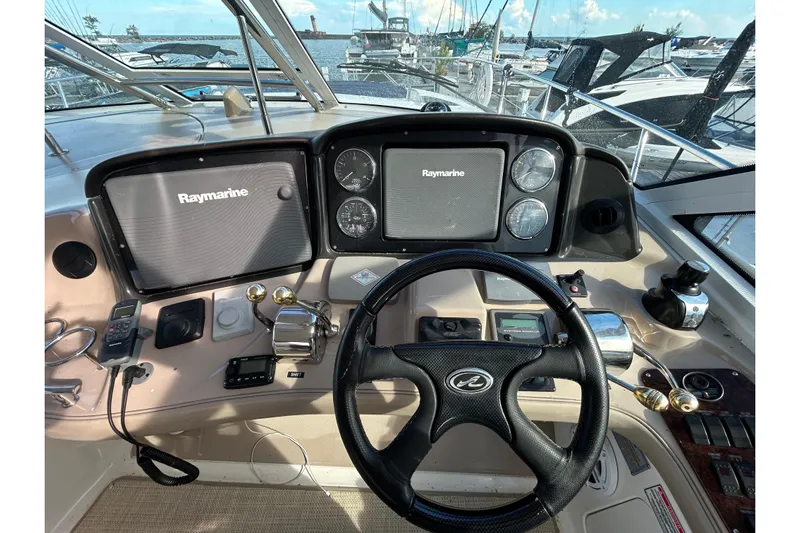 Blue Diamond Yacht Photos Pics Cockpit of 2005 Sea Ray 500 Sundancer with Raymarine navigation system and steering wheel.