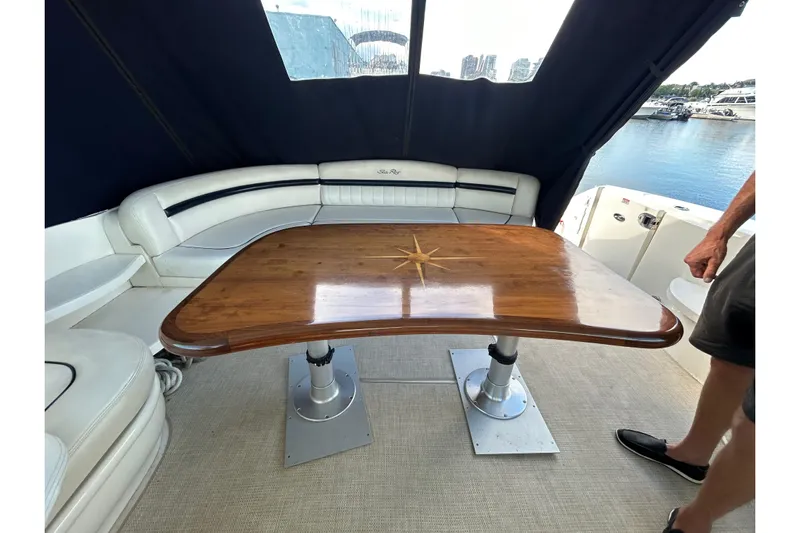 Blue Diamond Yacht Photos Pics 2005 Sea Ray 500 Sundancer yacht interior with wooden table and white seating.