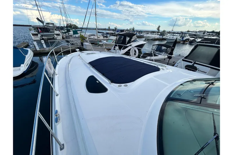 Blue Diamond Yacht Photos Pics 2005 Sea Ray 500 Sundancer yacht docked at marina under blue sky.