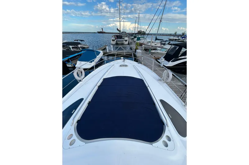 Blue Diamond Yacht Photos Pics 2005 Sea Ray 500 Sundancer yacht docked at marina under blue sky.