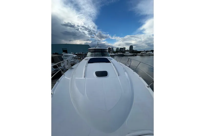 Blue Diamond Yacht Photos Pics 2005 Sea Ray 500 Sundancer yacht docked under a partly cloudy sky.