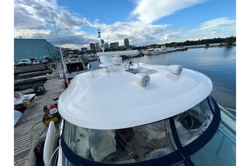 Blue Diamond Yacht Photos Pics 2005 Sea Ray 500 Sundancer yacht docked at marina with city skyline.