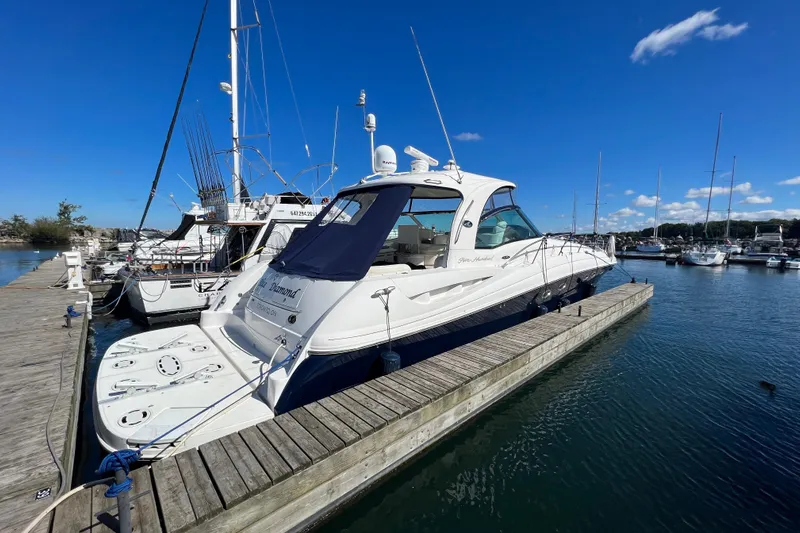 Blue Diamond Yacht Photos Pics 2005 Sea Ray 500 Sundancer yacht docked at marina under clear blue sky.