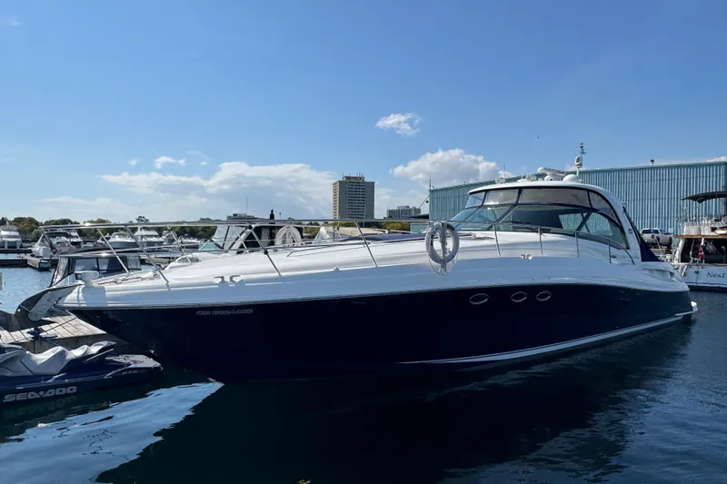 Blue Diamond Yacht Photos Pics 2005 Sea Ray 500 Sundancer yacht docked at marina under clear blue sky.