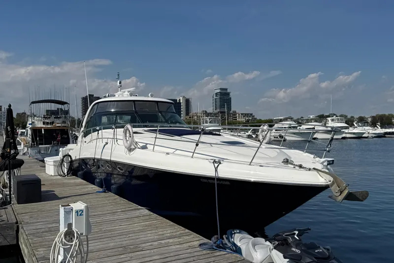 Blue Diamond Yacht Photos Pics 2005 Sea Ray 500 Sundancer yacht docked at marina under clear blue sky.