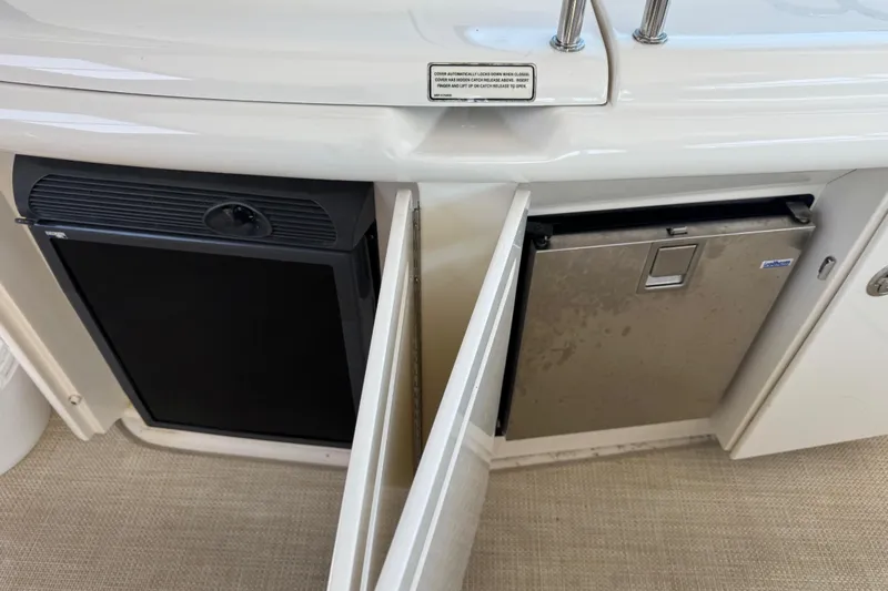 Blue Diamond Yacht Photos Pics 2005 Sea Ray 500 Sundancer yacht interior with open mini fridge and storage.