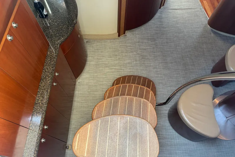 Blue Diamond Yacht Photos Pics Interior of 2005 Sea Ray 500 Sundancer yacht with elegant wood cabinetry and carpeted flooring.