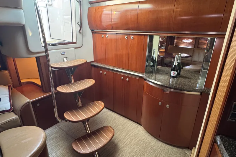 Blue Diamond Yacht Photos Pics 2005 Sea Ray 500 Sundancer interior with wooden cabinetry and spiral staircase.