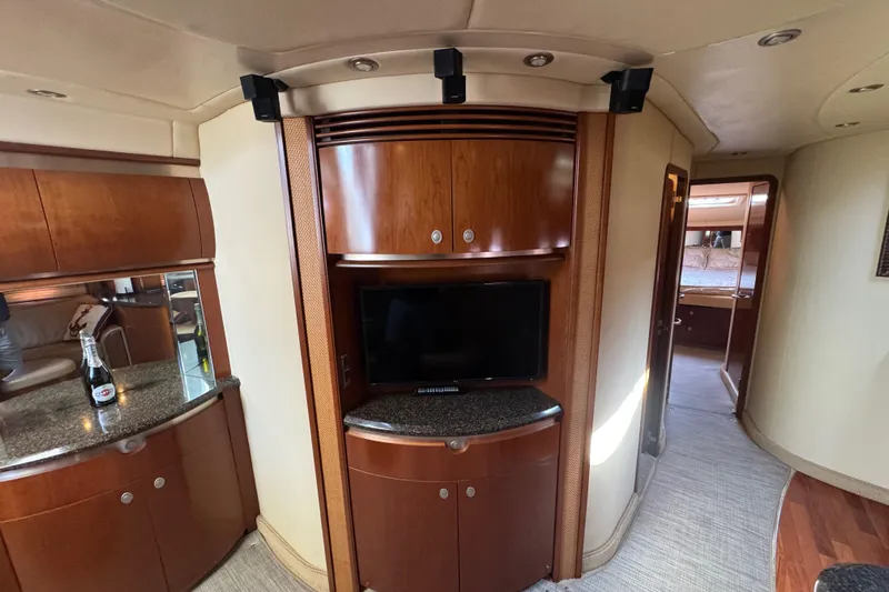 Blue Diamond Yacht Photos Pics Interior of 2005 Sea Ray 500 Sundancer yacht with wood cabinetry and TV.
