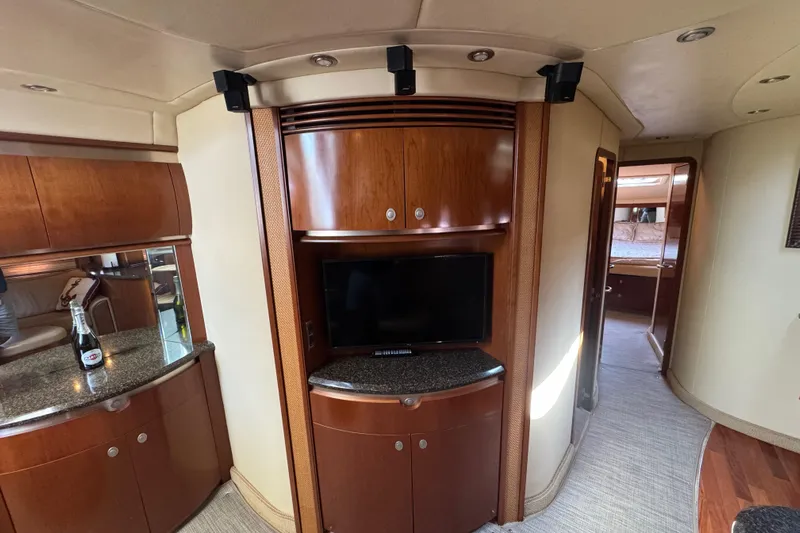 Blue Diamond Yacht Photos Pics Luxurious interior of 2005 Sea Ray 500 Sundancer yacht with wood cabinetry and TV.