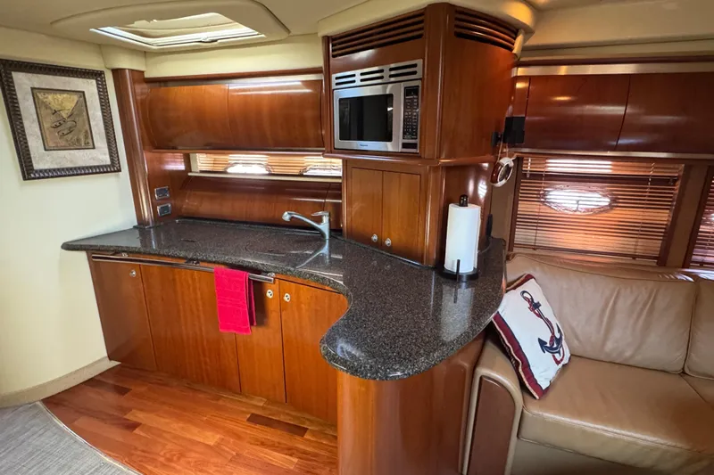 Blue Diamond Yacht Photos Pics Luxurious 2005 Sea Ray 500 Sundancer yacht interior with modern kitchen and cozy seating area.