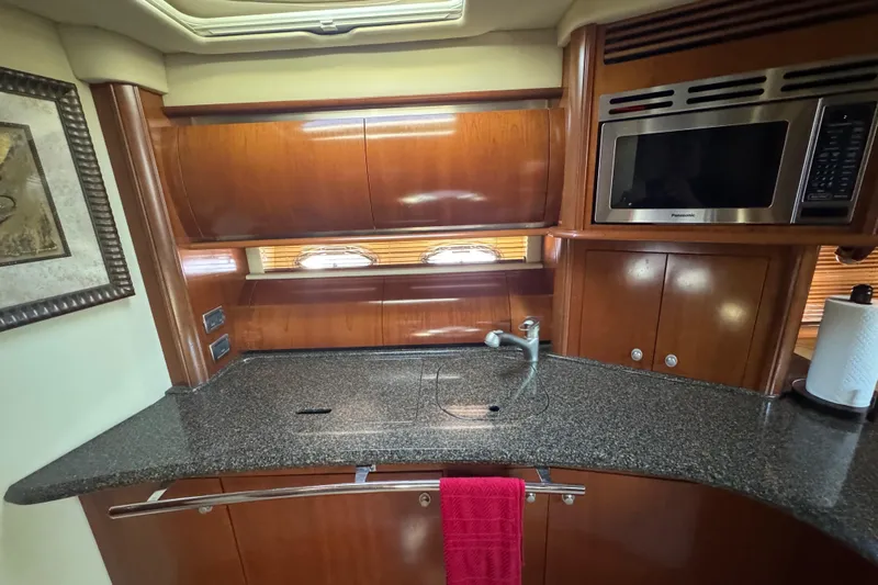Blue Diamond Yacht Photos Pics Luxurious 2005 Sea Ray 500 Sundancer yacht kitchen with wood cabinetry and modern appliances.