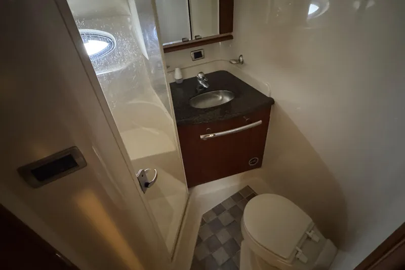 Blue Diamond Yacht Photos Pics Bathroom interior of 2005 Sea Ray 500 Sundancer yacht with shower, sink, and toilet.