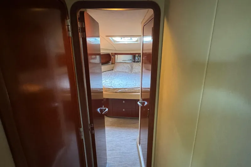 Blue Diamond Yacht Photos Pics Interior view of 2005 Sea Ray 500 Sundancer cabin with bed and wooden finishes.