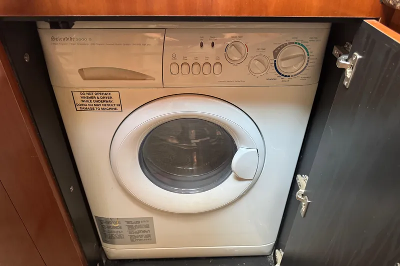 Blue Diamond Yacht Photos Pics Compact washer-dryer unit in a 2005 Sea Ray 500 Sundancer yacht interior.