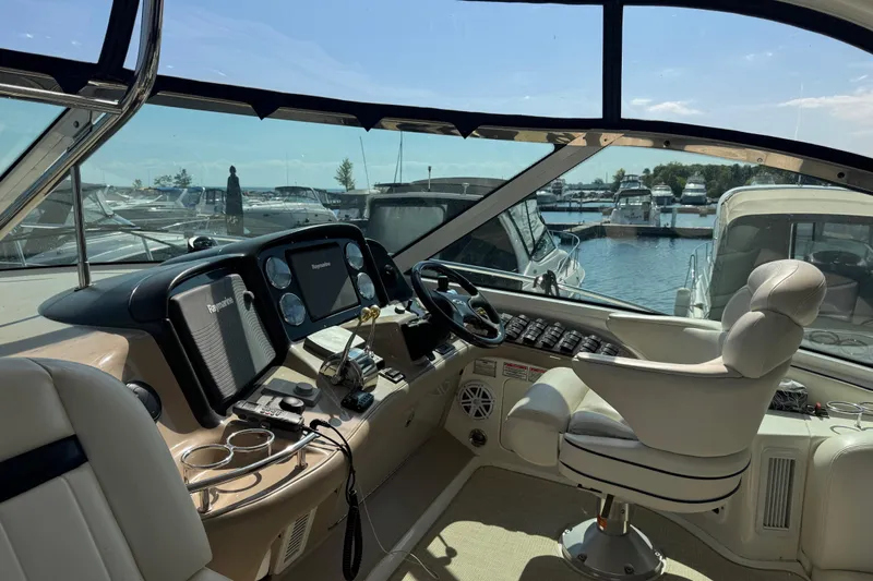 Blue Diamond Yacht Photos Pics Interior view of 2005 Sea Ray 500 Sundancer yacht cockpit with marina background.