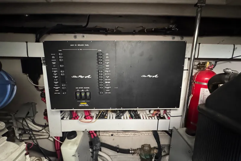 Blue Diamond Yacht Photos Pics Electrical panel of a 2005 Sea Ray 500 Sundancer boat, featuring wiring and fire extinguisher.