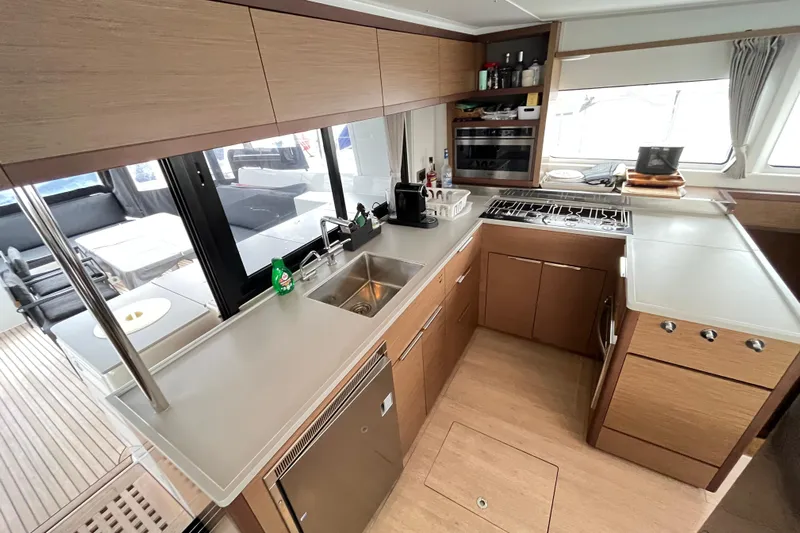 Alegr&iacute;a Yacht Photos Pics Modern kitchen interior of 2020 Lagoon 46 yacht with sleek cabinetry and appliances.