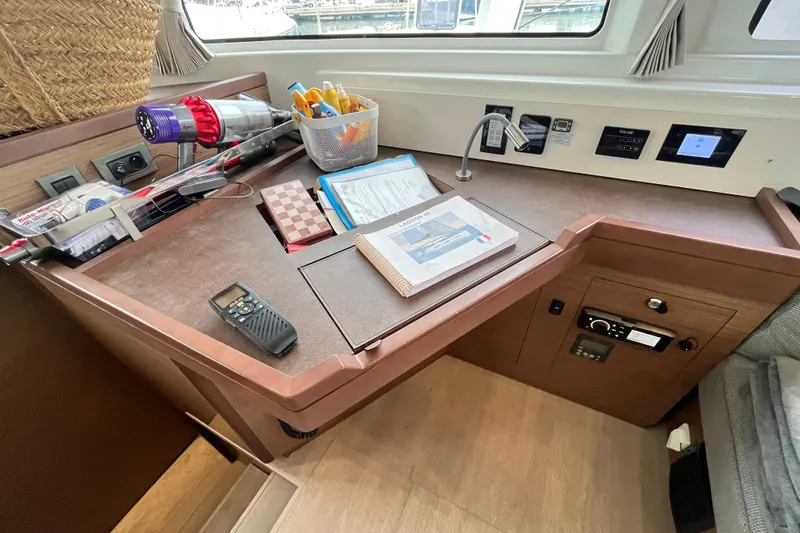 Alegr&iacute;a Yacht Photos Pics Navigation station on 2020 Lagoon 46 yacht with equipment and manuals.