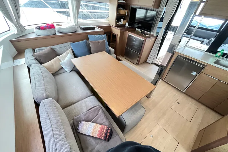 Alegr&iacute;a Yacht Photos Pics Luxurious interior of 2020 Lagoon 46 yacht with cozy seating and modern kitchen amenities.
