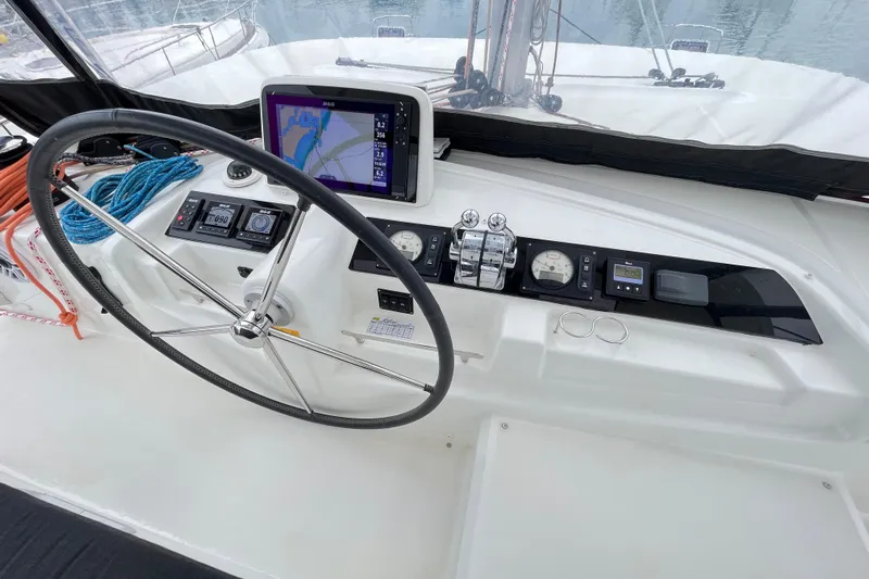 Alegr&iacute;a Yacht Photos Pics Helm of 2020 Lagoon 46 catamaran with navigation equipment and steering wheel.