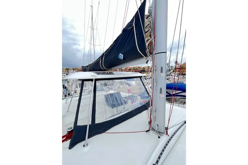Alegr&iacute;a Yacht Photos Pics 2020 Lagoon 46 catamaran with sails docked at marina, featuring sleek design and modern rigging.