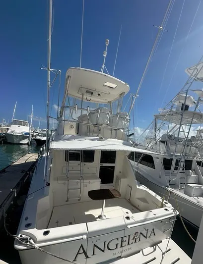  Yacht Photos Pics 2004 Riviera 37 Convertible yacht docked at marina under clear blue sky.