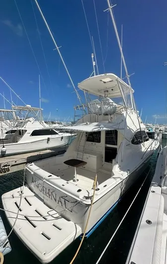  Yacht Photos Pics 2004 Riviera 37 Convertible yacht docked at marina under clear blue sky.