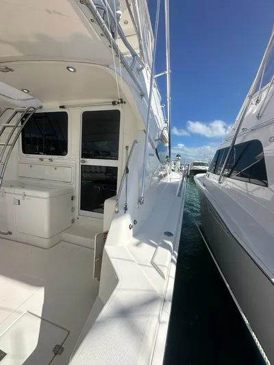  Yacht Photos Pics 2004 Riviera 37 Convertible yacht docked under clear blue sky.