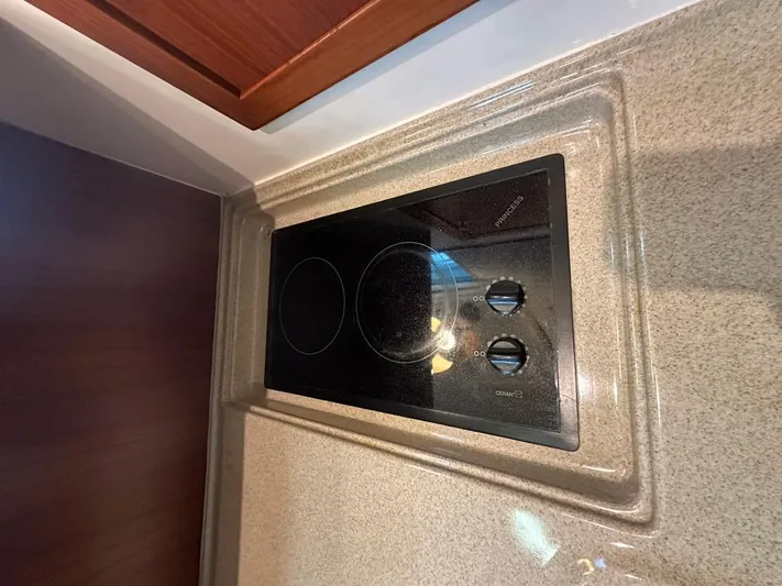  Yacht Photos Pics Electric stovetop in 2004 Riviera 37 Convertible yacht kitchen.