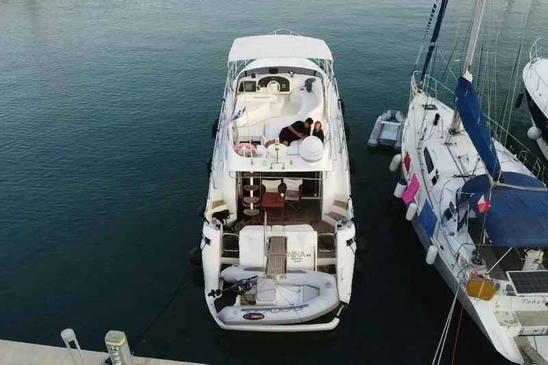 Nina Yacht Photos Pics Aerial view of a 2000 Azimut 52 yacht docked at a marina.