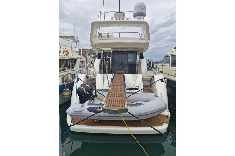 Nina Yacht Photos Pics Azimut 52 yacht from 2000 docked with inflatable boat and wooden gangway.