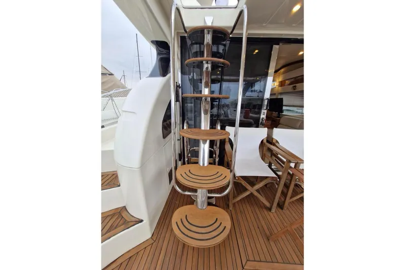 Nina Yacht Photos Pics Staircase on 2000 Azimut 52 yacht with wooden steps and sleek design.