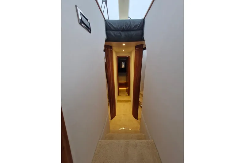 Nina Yacht Photos Pics Interior hallway of a 2000 Azimut 52 yacht, featuring elegant wood accents.