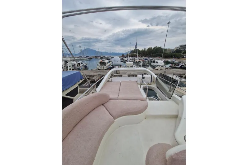 Nina Yacht Photos Pics Azimut 52 yacht, 2000 model, docked at marina with scenic mountain backdrop.