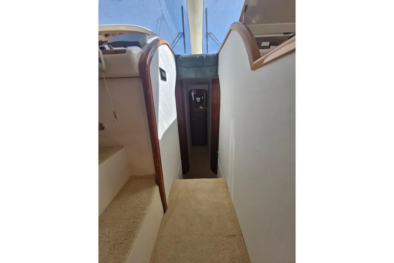 Nina Yacht Photos Pics Interior view of 2000 Azimut 52 yacht, featuring carpeted stairs and wooden accents.