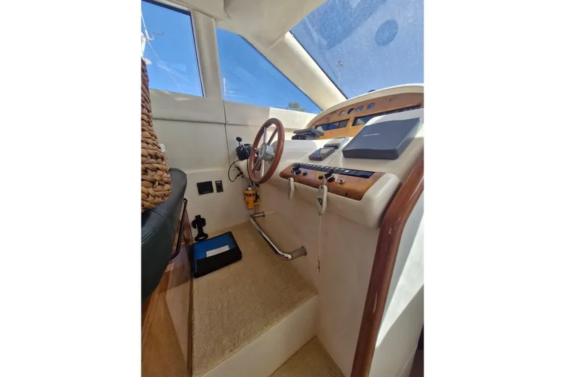 Nina Yacht Photos Pics Cockpit of 2000 Azimut 52 yacht with steering wheel and navigation controls.