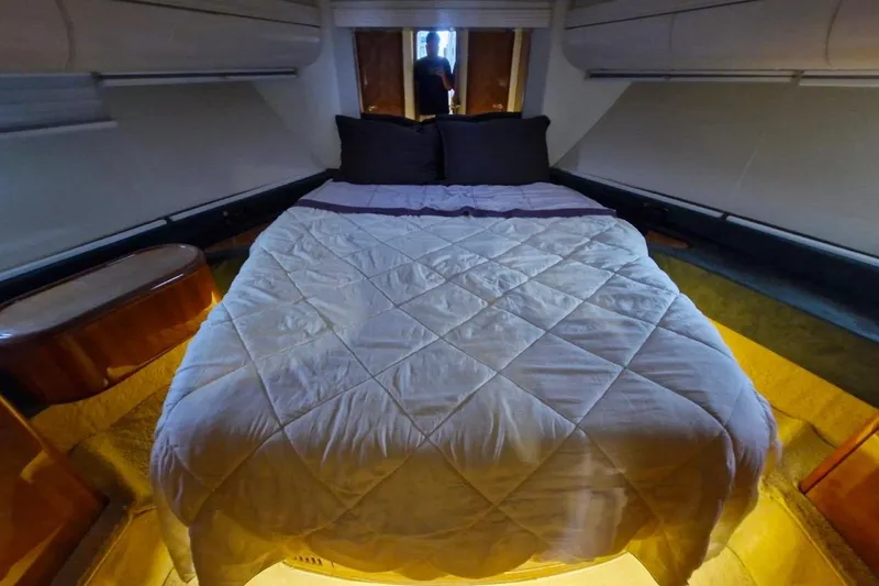 Nina Yacht Photos Pics Luxurious bedroom interior of a 2000 Azimut 52 yacht with cozy bedding.