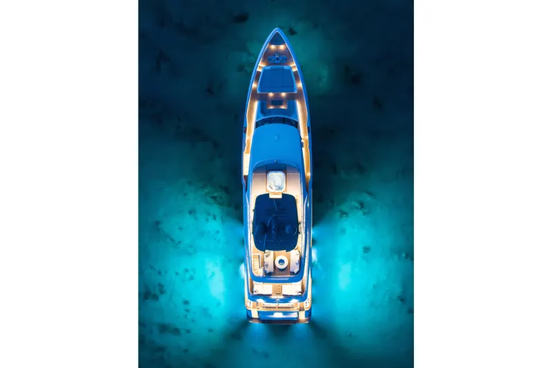 Sk Yacht Photos Pics Aerial view of illuminated 2019 Custom Line Navetta 33 yacht on serene blue water.