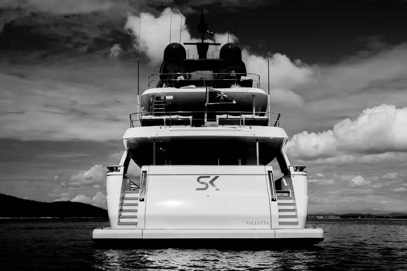 Sk Yacht Photos Pics Sleek 2019 Custom Line Navetta 33 yacht on calm waters, dramatic sky backdrop.