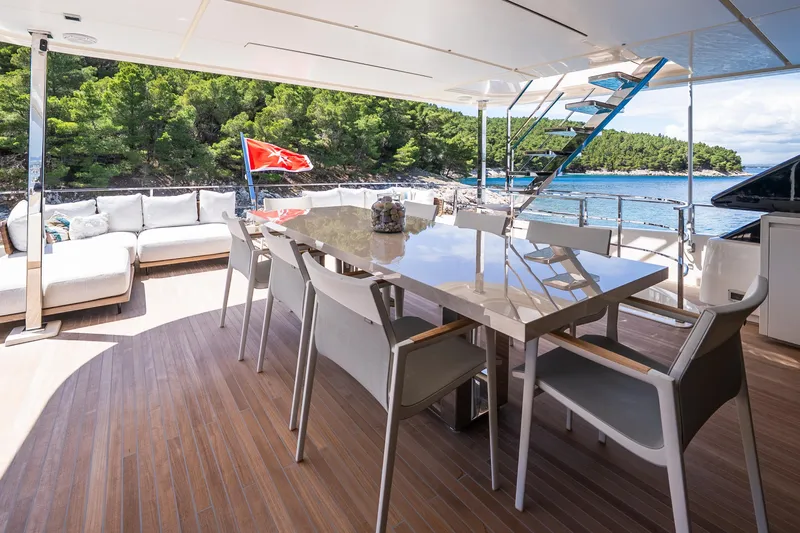Sk Yacht Photos Pics Luxurious 2019 Custom Line Navetta 33 yacht deck with dining area and scenic ocean view.