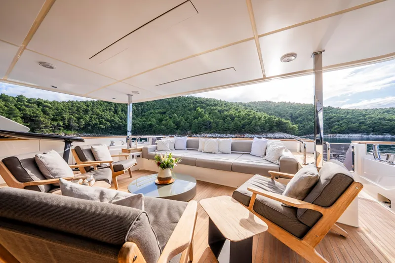 Sk Yacht Photos Pics Luxurious 2019 Custom Line Navetta 33 yacht deck with elegant seating and scenic ocean view.