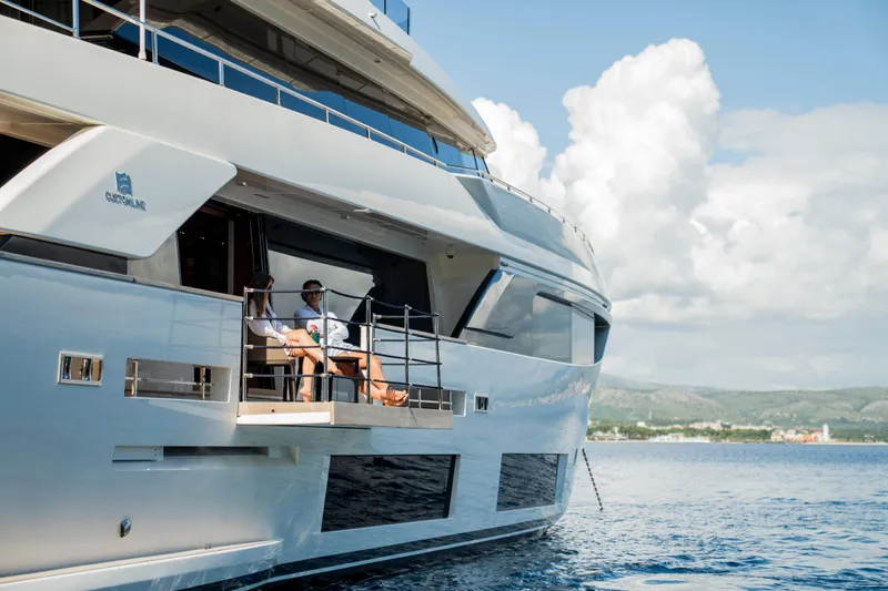 Sk Yacht Photos Pics Luxury yacht Custom Line Navetta 33, 2019 model, with people relaxing on deck.