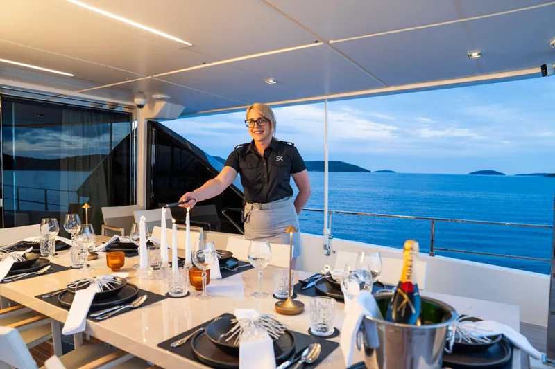 Sk Yacht Photos Pics Luxury dining setup on 2019 Custom Line Navetta 33 yacht, with ocean view and elegant table setting.