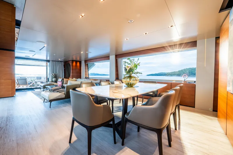 Sk Yacht Photos Pics Luxurious interior of 2019 Custom Line Navetta 33 yacht with elegant dining area and scenic views.