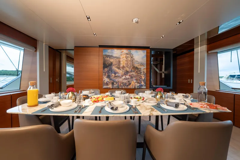Sk Yacht Photos Pics Luxurious dining area on 2019 Custom Line Navetta 33 yacht, elegantly set table with artwork.
