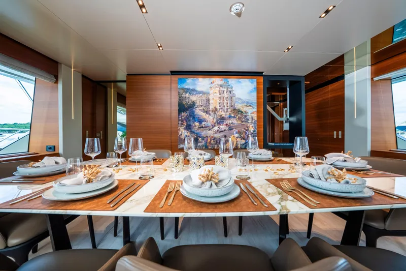 Sk Yacht Photos Pics Luxurious dining area on 2019 Custom Line Navetta 33 yacht, featuring elegant table settings and artwork.