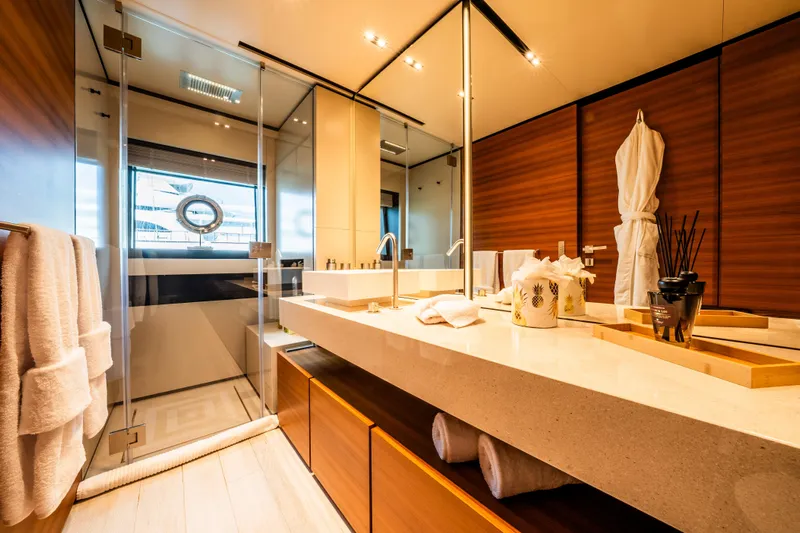 Sk Yacht Photos Pics Luxurious bathroom on 2019 Custom Line Navetta 33 yacht, featuring elegant wood and glass design.