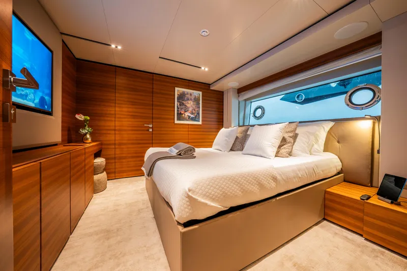 Sk Yacht Photos Pics Luxurious bedroom interior on 2019 Custom Line Navetta 33 yacht, featuring elegant wood paneling.