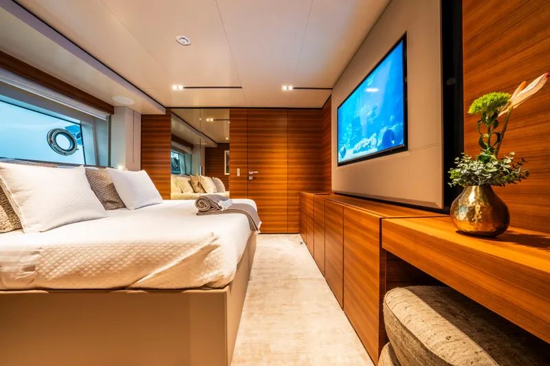 Sk Yacht Photos Pics Luxurious bedroom interior on 2019 Custom Line Navetta 33 yacht with modern decor and large TV.
